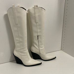 White wedge heel cowboy boots.